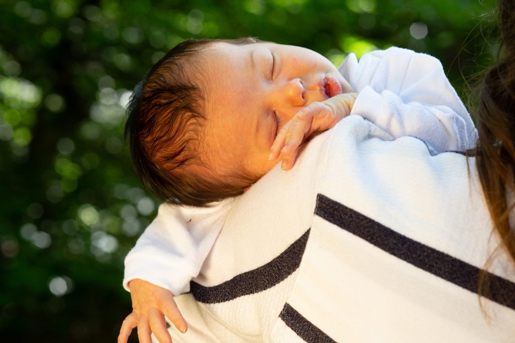 Baby sleeping on his mother's shoulder