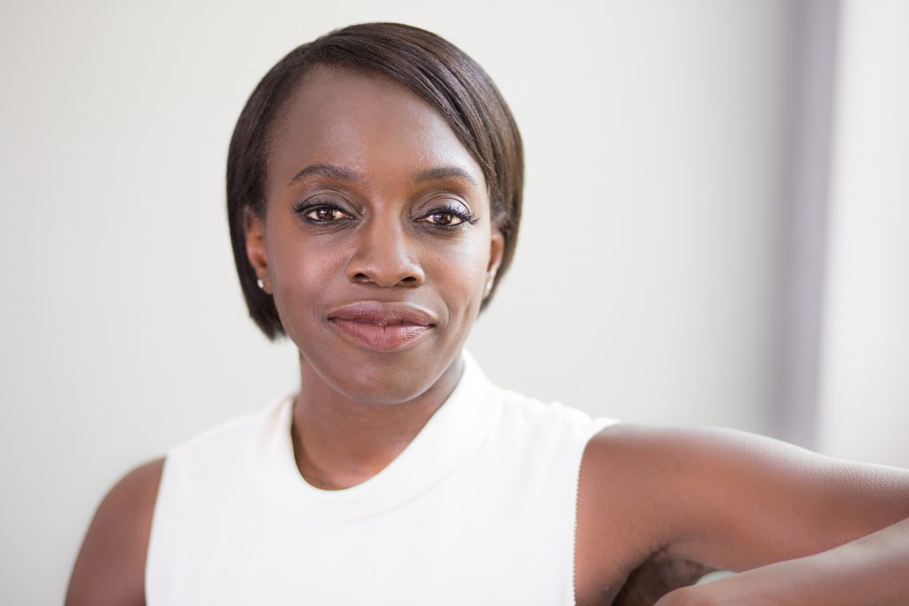 Black business woman staring into camera